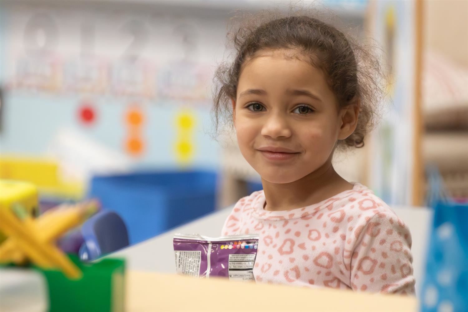 A student smiles at the camera